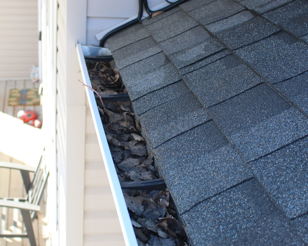 A gutter before being professionally cleaned