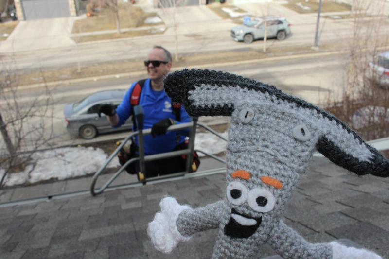 Kyle from Touch of Glass on a gutter cleaning job in Calgary